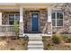 Inviting front porch featuring stone pillars and a charming blue front door at 868 N Quatar St, Aurora, CO 80018