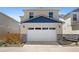 Attached two-car garage showcasing painted siding and a blue roof at 868 N Quatar St, Aurora, CO 80018