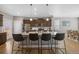 Modern kitchen featuring a granite island, stainless steel appliances, and stylish bar stools at 868 N Quatar St, Aurora, CO 80018
