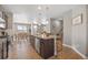 Open kitchen featuring granite island with seating, stainless steel appliances, and adjacent dining area at 868 N Quatar St, Aurora, CO 80018