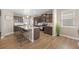 Contemporary kitchen with a large island, stainless steel appliances, and dark wood cabinets at 868 N Quatar St, Aurora, CO 80018