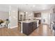 Beautiful kitchen with a large granite island, stainless steel appliances, and hardwood floors at 868 N Quatar St, Aurora, CO 80018