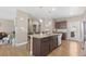 Beautiful kitchen with a large granite island, stainless steel appliances, and hardwood floors at 868 N Quatar St, Aurora, CO 80018