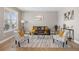 Spacious living room with stylish decor, a leather sofa, and large windows at 868 N Quatar St, Aurora, CO 80018