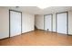 Unfinished basement space featuring wood-look flooring and 3 white doors with black trim at 7732 Xavier Ct, Westminster, CO 80030