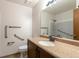 Bright bathroom featuring a vanity with solid-surface countertop and safety assist bars at 7732 Xavier Ct, Westminster, CO 80030