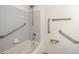 Accessible bathroom features include grab bars and a shower head for safe and convenient bathing at 7732 Xavier Ct, Westminster, CO 80030