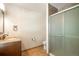 Well-lit bathroom featuring a granite vanity top, tiled floor and glass-enclosed shower at 7732 Xavier Ct, Westminster, CO 80030