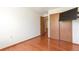 Bedroom boasts wood floors and built in wardrobe with sliding wood doors at 7732 Xavier Ct, Westminster, CO 80030