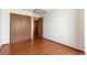 Bedroom with wood floors featuring double closet with wood doors at 7732 Xavier Ct, Westminster, CO 80030