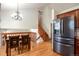 Open kitchen and dining area featuring stainless steel appliances and a wooden staircase at 7732 Xavier Ct, Westminster, CO 80030