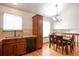 Inviting eat-in kitchen with sleek appliances, lots of natural light and a modern chandelier at 7732 Xavier Ct, Westminster, CO 80030