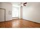 Bright living room with beautiful hardwood floors and a large arch window at 7732 Xavier Ct, Westminster, CO 80030