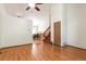 Open living space with hardwood floors leading to a dining area and wooden staircase at 7732 Xavier Ct, Westminster, CO 80030