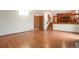 Large open room with hardwood floors, neutral walls, and stairs to the kitchen at 7732 Xavier Ct, Westminster, CO 80030