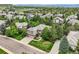 Beautiful aerial view of a two-story home with a well-maintained lawn and mature trees in a suburban neighborhood at 10529 Dacre Pl, Lone Tree, CO 80124