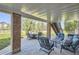Covered patio seating area providing a comfortable outdoor space with scenic views of the backyard at 10529 Dacre Pl, Lone Tree, CO 80124