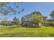 Spacious backyard featuring a raised deck, lower patio, lush lawn, mature trees, and privacy landscaping at 10529 Dacre Pl, Lone Tree, CO 80124