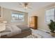 Cozy bedroom features neutral walls, plush carpet, and a bright window with scenic views at 10529 Dacre Pl, Lone Tree, CO 80124
