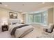 Serene bedroom with a bay window seating area providing lots of natural light at 10529 Dacre Pl, Lone Tree, CO 80124