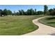 Inviting grassy common area featuring a winding path surrounded by trees at 10529 Dacre Pl, Lone Tree, CO 80124