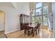 A dining room has a large window and a wooden table with seating at 10529 Dacre Pl, Lone Tree, CO 80124