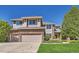 Charming two-story home with a well-manicured lawn and a two-car garage at 10529 Dacre Pl, Lone Tree, CO 80124