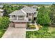 Charming two-story home with manicured lawn, mature trees, and a brick-accented, two-car garage at 10529 Dacre Pl, Lone Tree, CO 80124