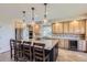 Kitchen with large center island and seating, stainless steel appliances, and wood cabinets at 10529 Dacre Pl, Lone Tree, CO 80124