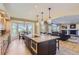 Open-concept kitchen with island seating, granite countertops, stainless appliances, and breakfast nook at 10529 Dacre Pl, Lone Tree, CO 80124