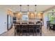 Kitchen with central island, seating, stainless appliances, and light wood cabinetry at 10529 Dacre Pl, Lone Tree, CO 80124