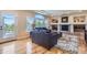 A living room features a fireplace, built-in shelves, and large windows at 10529 Dacre Pl, Lone Tree, CO 80124
