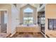 Bright and spacious main bathroom features a soaking tub, large window, and glass shower at 10529 Dacre Pl, Lone Tree, CO 80124
