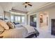 Spacious main bedroom boasts large windows, vaulted ceilings, cozy sitting area, and ensuite bathroom at 10529 Dacre Pl, Lone Tree, CO 80124