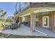 Outdoor patio with comfortable seating, brick columns and a staircase to an upper balcony at 10529 Dacre Pl, Lone Tree, CO 80124
