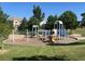 Community playground with swings, slides, and play structures for Gathering fun at 10529 Dacre Pl, Lone Tree, CO 80124