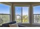 Comfortable sitting area features three large windows offering backyard views and natural light at 10529 Dacre Pl, Lone Tree, CO 80124