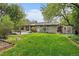 Exterior view of home features large backyard and patio, perfect for outdoor living at 395 Zephyr St, Lakewood, CO 80226
