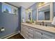Well-lit bathroom with a double vanity, granite countertops, and classic fixtures at 395 Zephyr St, Lakewood, CO 80226