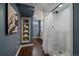 Stylish bathroom features white tiled shower, mosaic tile floor, and convenient built-in shelving at 395 Zephyr St, Lakewood, CO 80226