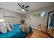 This bedroom features a hardwood floor and natural light from the two windows at 395 Zephyr St, Lakewood, CO 80226