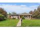 Charming single-story home featuring a covered porch and lush front lawn at 395 Zephyr St, Lakewood, CO 80226