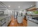 Spacious kitchen with stainless steel appliances and granite countertops overlooking hardwood floors at 395 Zephyr St, Lakewood, CO 80226