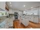 Updated kitchen features granite counters, stainless appliances, and hardwood floors at 395 Zephyr St, Lakewood, CO 80226