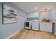 Laundry room with modern washer and dryer, shaker cabinets and a light fixture at 395 Zephyr St, Lakewood, CO 80226