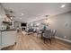 Open-concept space featuring a fireplace, a dining area and a bar area with floating shelves at 395 Zephyr St, Lakewood, CO 80226