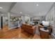 Open-concept living room with hardwood floors, a fireplace, and a view to the kitchen at 395 Zephyr St, Lakewood, CO 80226