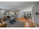 Open living space featuring hardwood floors, dining area, living area and bar seating at 395 Zephyr St, Lakewood, CO 80226