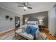 Beautiful main bedroom featuring a ceiling fan, a decorative headboard, and wood floors at 395 Zephyr St, Lakewood, CO 80226
