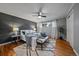 Stylish main bedroom featuring gray accent wall, ceiling fan and hardwood floors at 395 Zephyr St, Lakewood, CO 80226